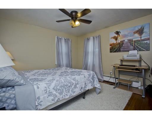 28 Barton Street Springfield, MA 01104 - Photo 12 of 26 a bedroom with a bed and a chandelier