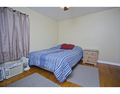 28 Barton Street Springfield, MA 01104 - Photo 13 of 26 a bedroom with a bed and a dresser