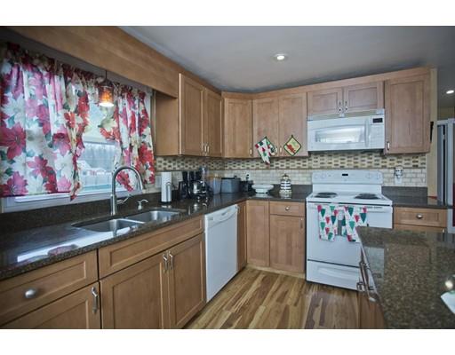 28 Barton Street Springfield, MA 01104 - Photo 4 of 26 a kitchen with granite countertop a sink stove and cabinets