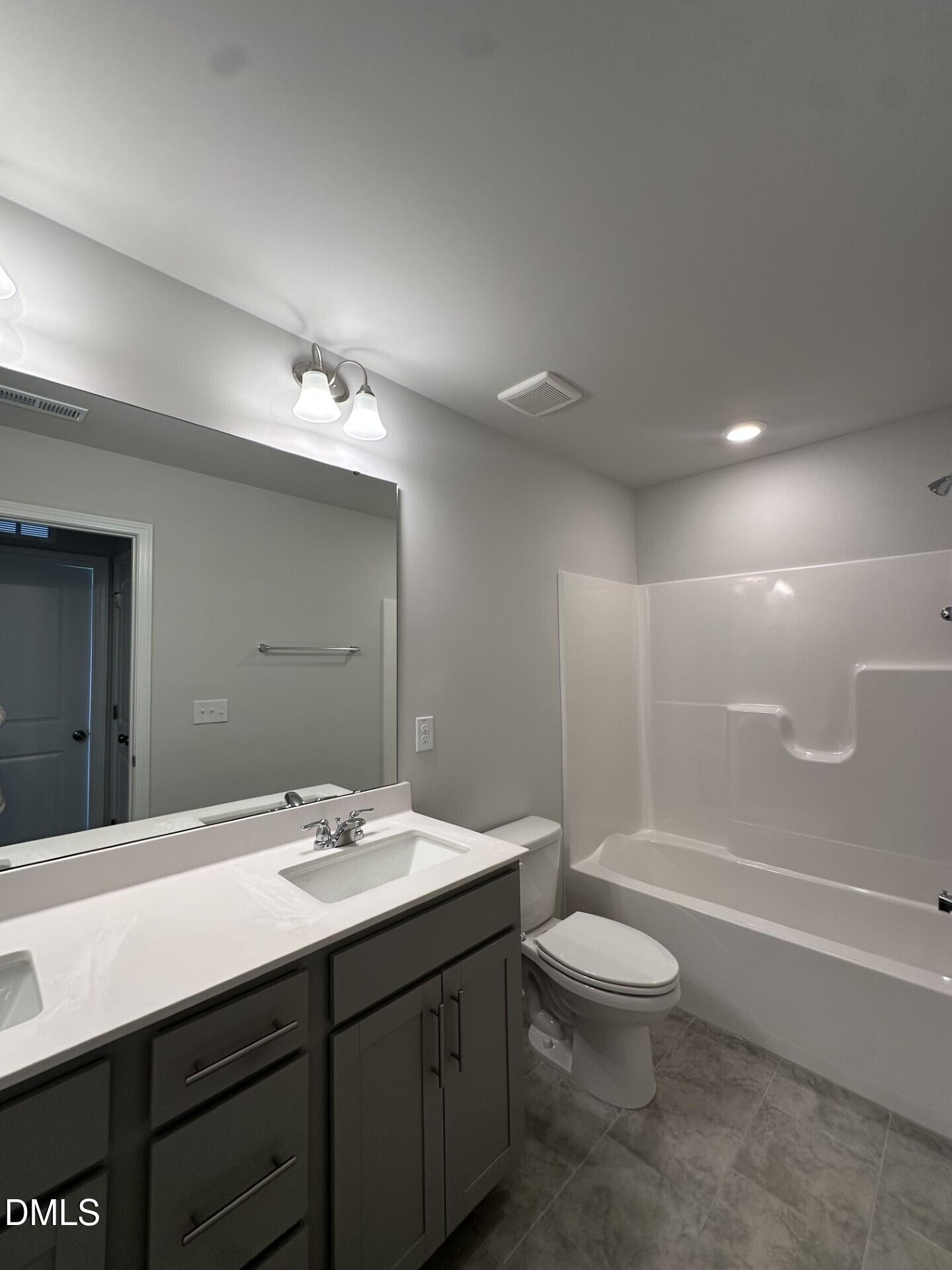 507 Hester Road Durham, NC 27703 - Photo 11 of 33 a bathroom with a double vanity sink toilet and shower