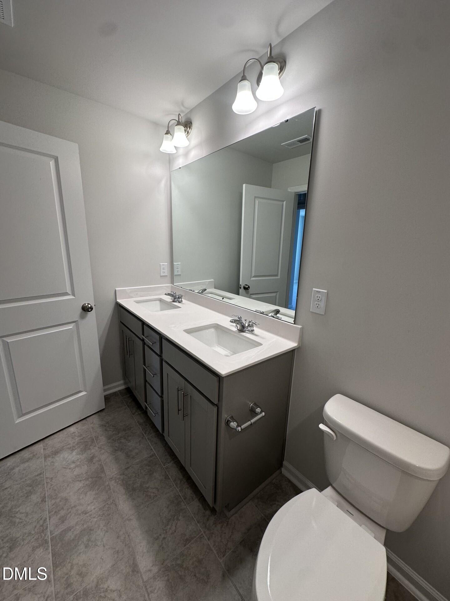 507 Hester Road Durham, NC 27703 - Photo 12 of 33 a bathroom with a toilet sink and mirror