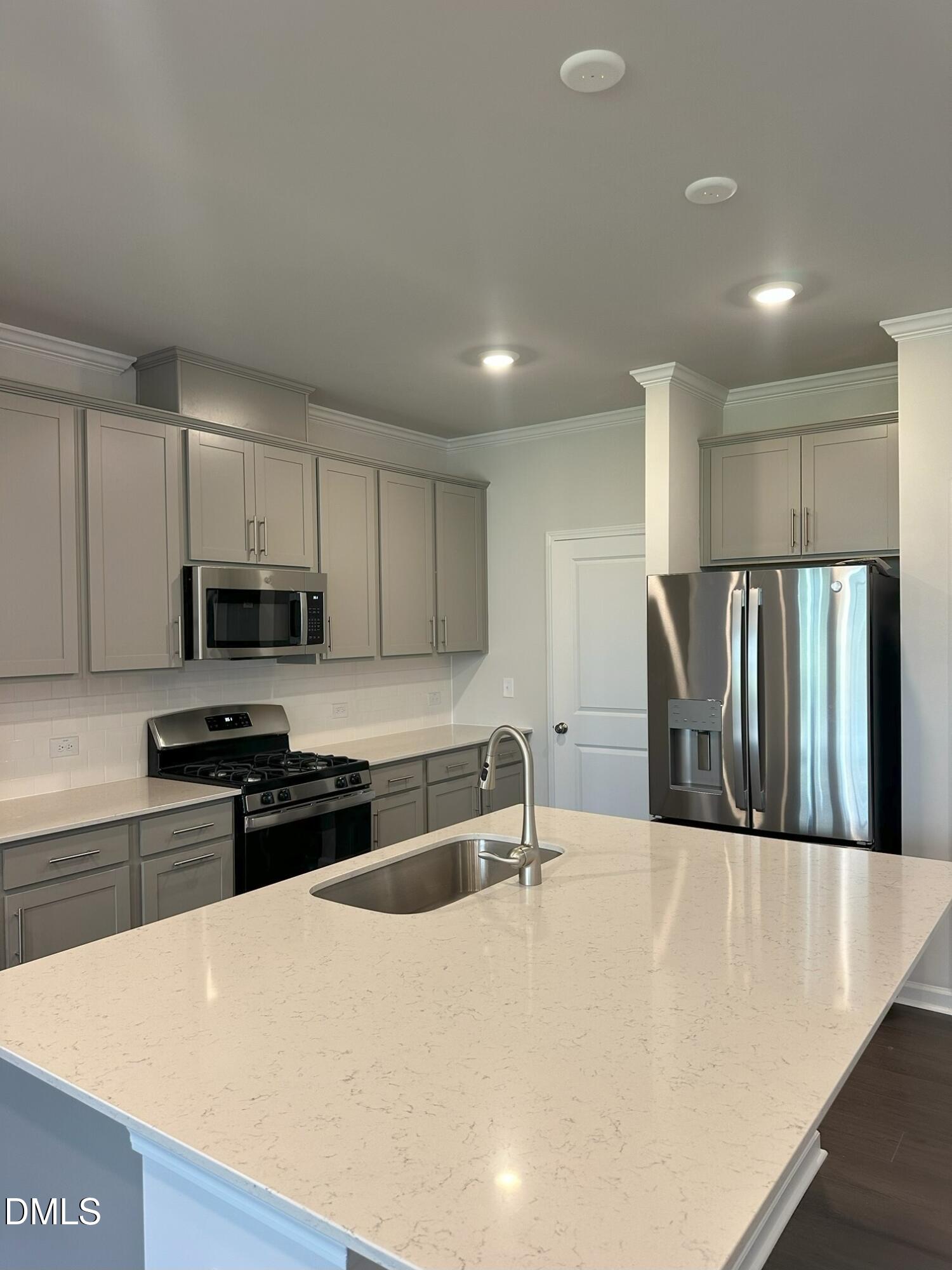 507 Hester Road Durham, NC 27703 - Photo 3 of 33 a kitchen with stainless steel appliances granite countertop a sink a stove a refrigerator a microwave and cabinets