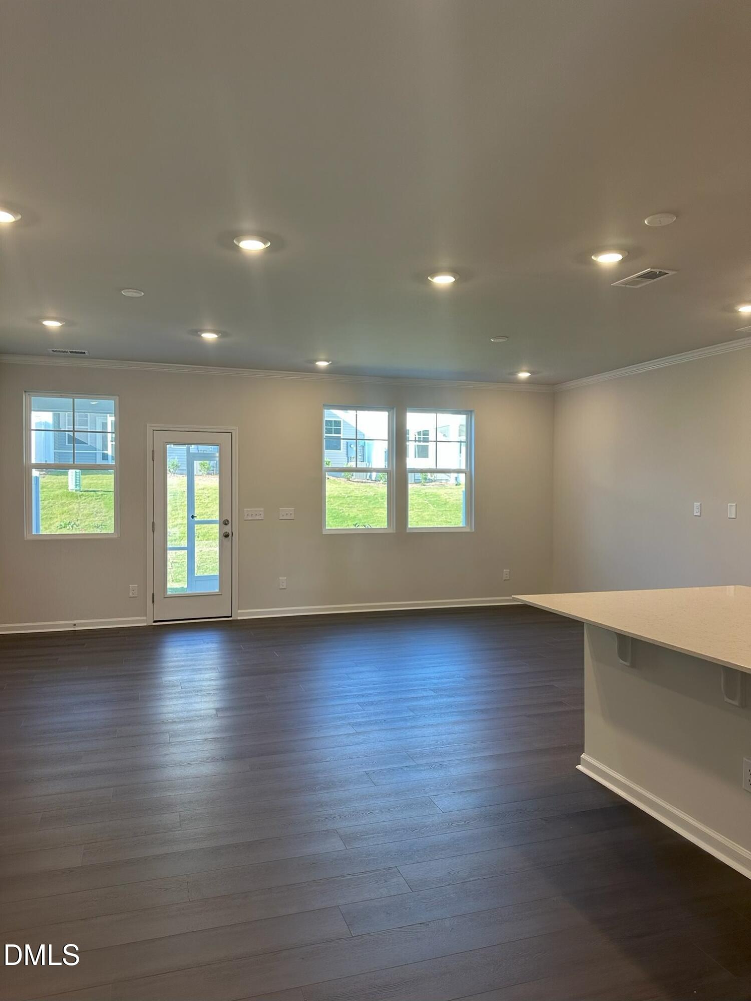 507 Hester Road Durham, NC 27703 - Photo 5 of 33 an empty room with wooden floor and windows