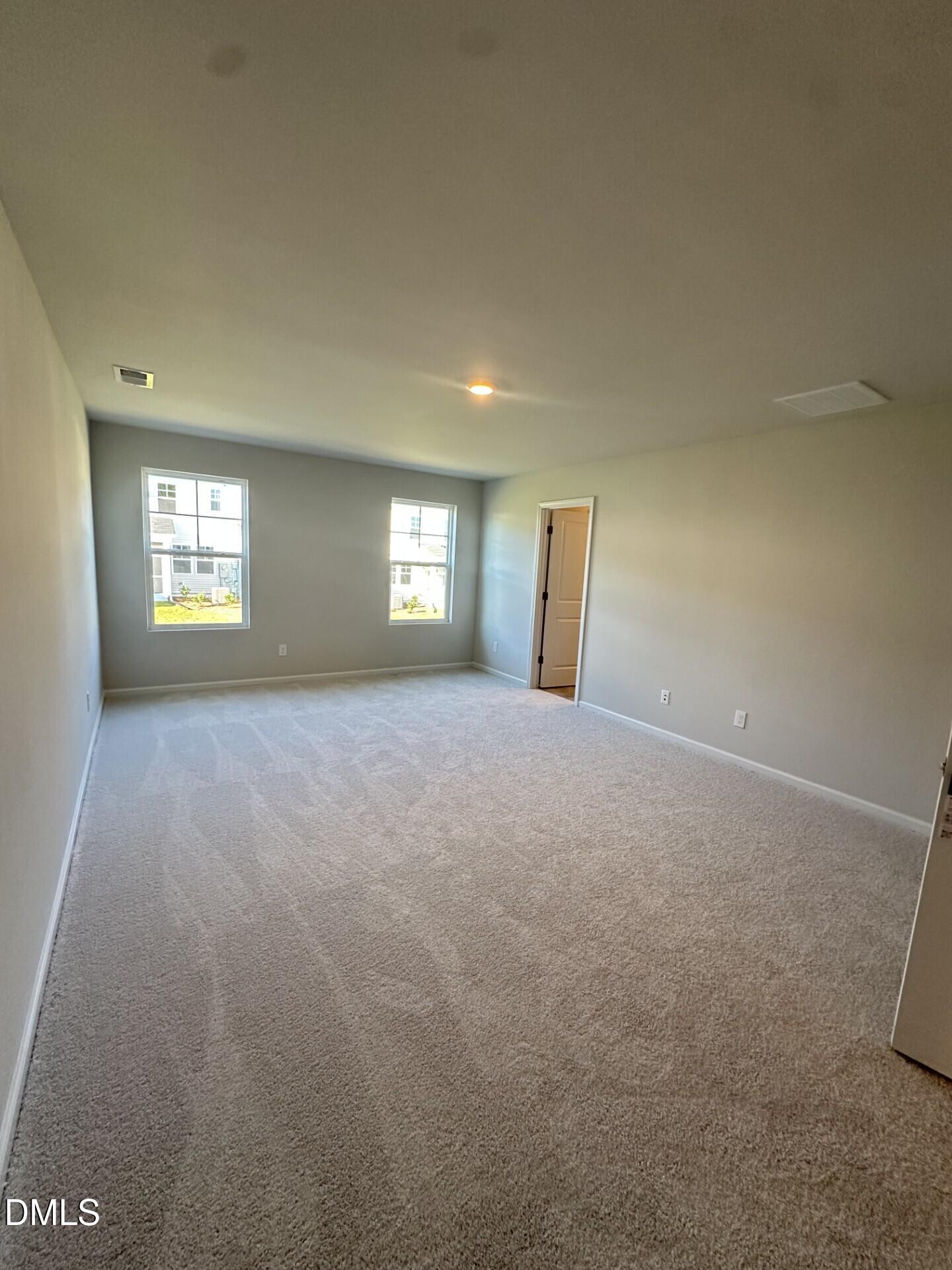 507 Hester Road Durham, NC 27703 - Photo 7 of 33 a view of an empty room with windows and closet area