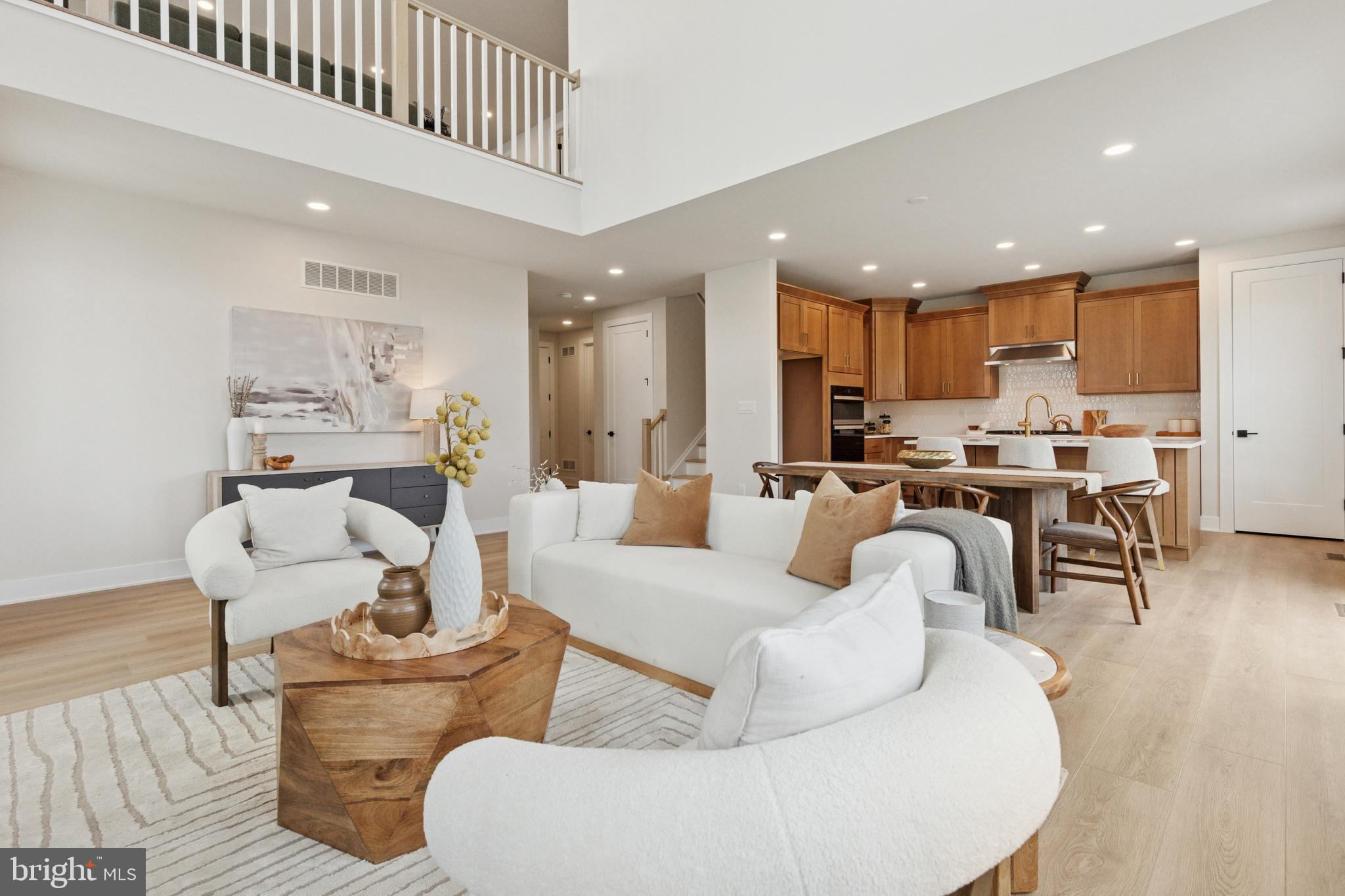 a living room with furniture and kitchen view