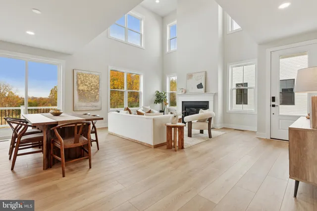 a living room with fireplace furniture and a large window