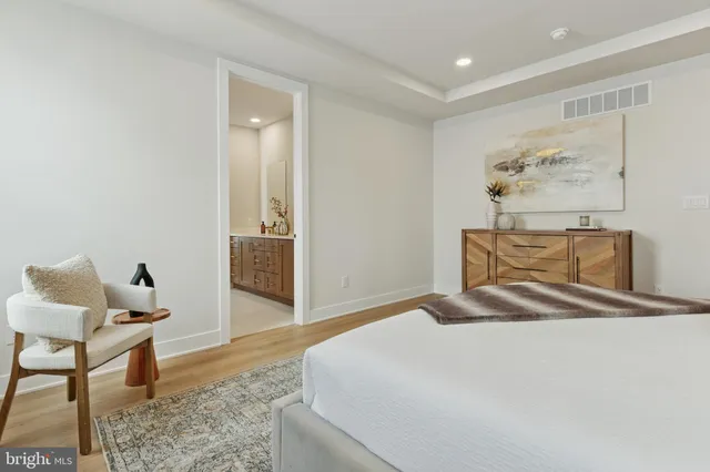 a bedroom with a bed and chair