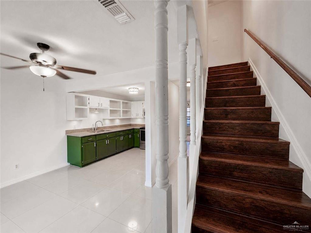 2201 South Jackson Road, Unit 2I Pharr, TX 78577 - Photo 9 of 23 Rich wood-finish staircase with white balusters and handrail