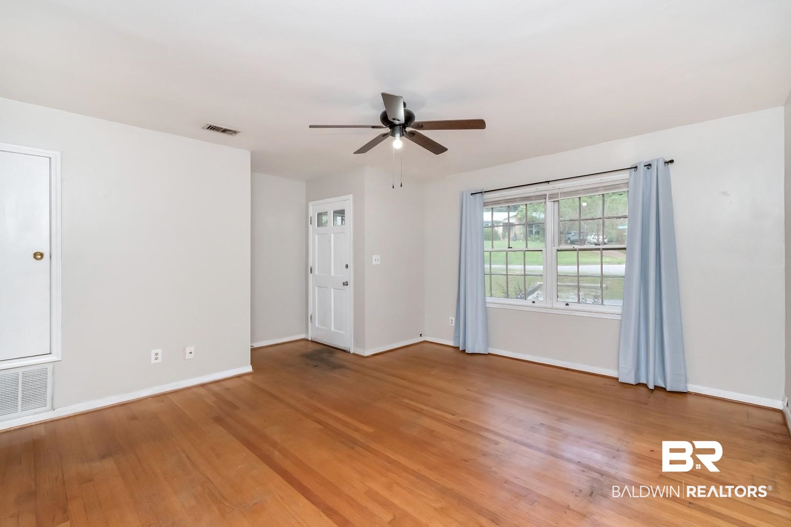 320 Vanderbilt Drive Mobile, AL 36608 - Photo 9 of 39 Spare room with wood-type flooring and ceiling fan