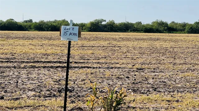 a sign board with river and trees