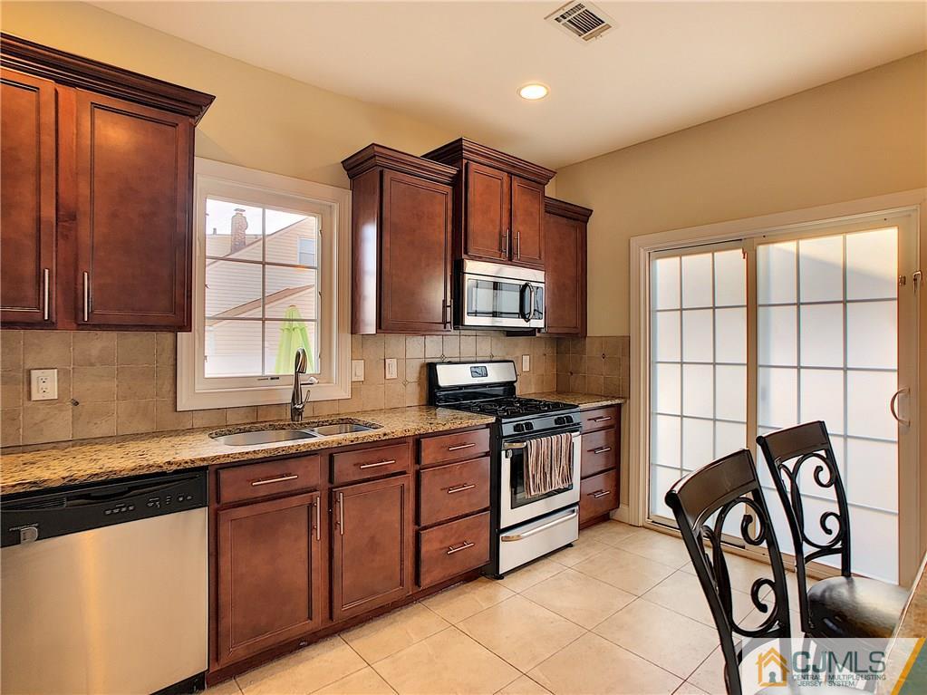 724 Palisade Road Union, NJ 07083 - Photo 6 of 20 a kitchen with stainless steel appliances granite countertop a sink stove and cabinets