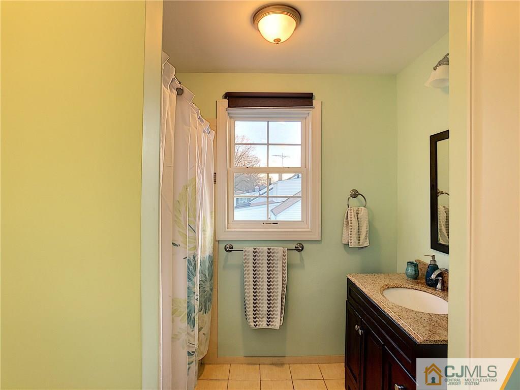 724 Palisade Road Union, NJ 07083 - Photo 10 of 20 a bathroom with a sink a toilet and mirror