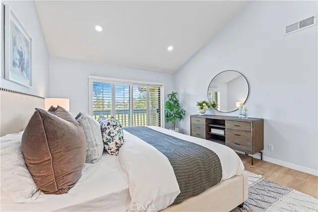 an aerial view of residential houses with outdoor space and trees