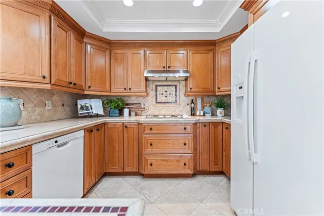 a kitchen with stainless steel appliances a refrigerator and cabinets