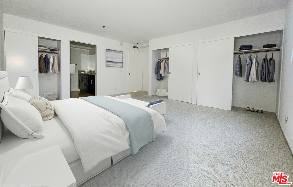 832 3rd Street, Unit 203 Santa Monica, CA 90403 - Photo 13 of 16 a bedroom with a bed and walk in closet