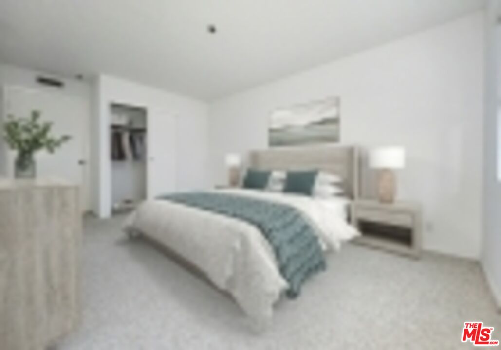 832 3rd Street, Unit 203 Santa Monica, CA 90403 - Photo 15 of 16 a bedroom with a bed and a painting on the wall
