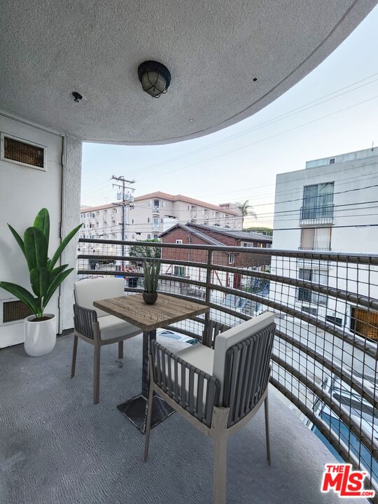 832 3rd Street, Unit 203 Santa Monica, CA 90403 - Photo 4 of 16 a roof deck with table and chairs