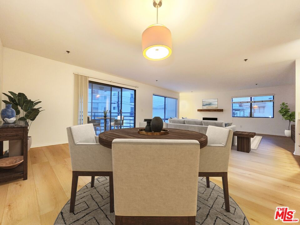 832 3rd Street, Unit 203 Santa Monica, CA 90403 - Photo 5 of 16 a living room with furniture a dining table and a large window