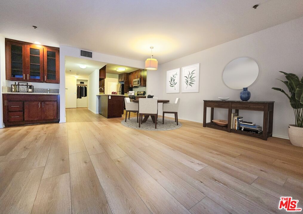 832 3rd Street, Unit 203 Santa Monica, CA 90403 - Photo 7 of 16 a living room with fireplace furniture and a wooden floor