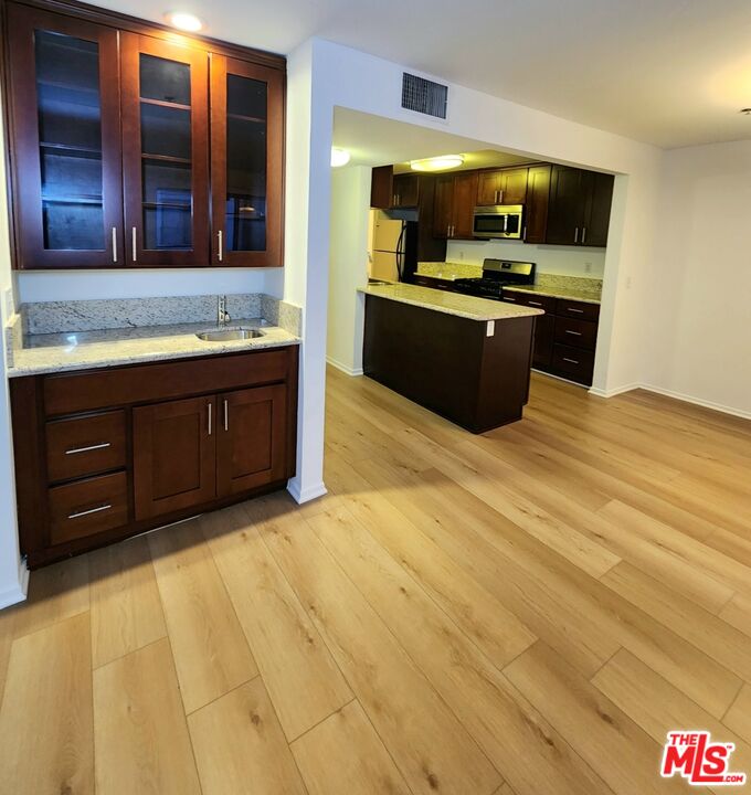832 3rd Street, Unit 203 Santa Monica, CA 90403 - Photo 10 of 16 a kitchen with stainless steel appliances granite countertop a stove and a sink