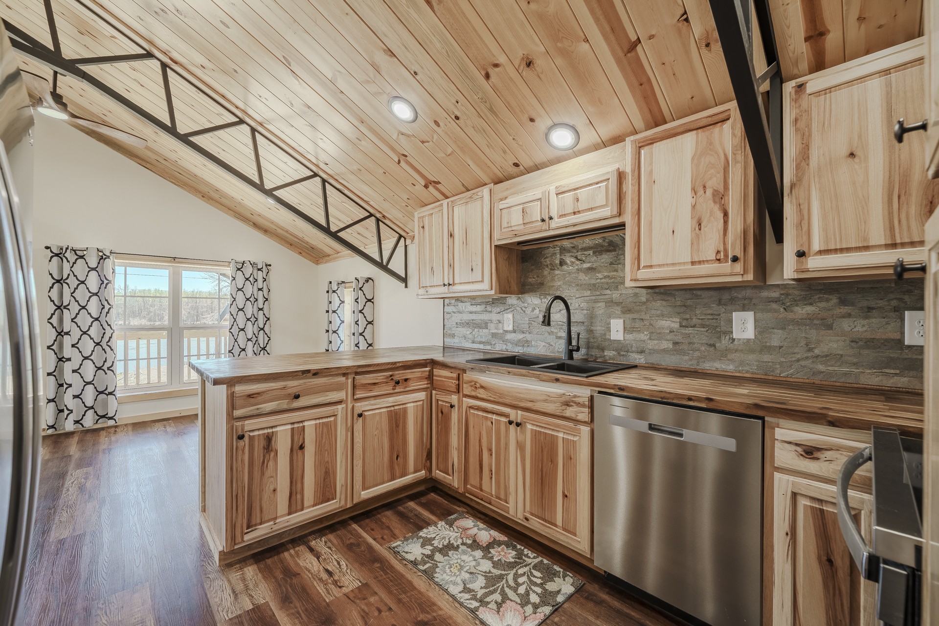 1082 WC PICKETT Road Clifton, TN 38425 - Photo 19 of 75 a kitchen with stainless steel appliances granite countertop a sink and wooden cabinets with wooden floors