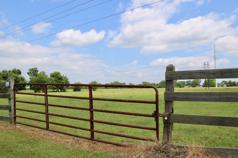 a view of a street with a big yard