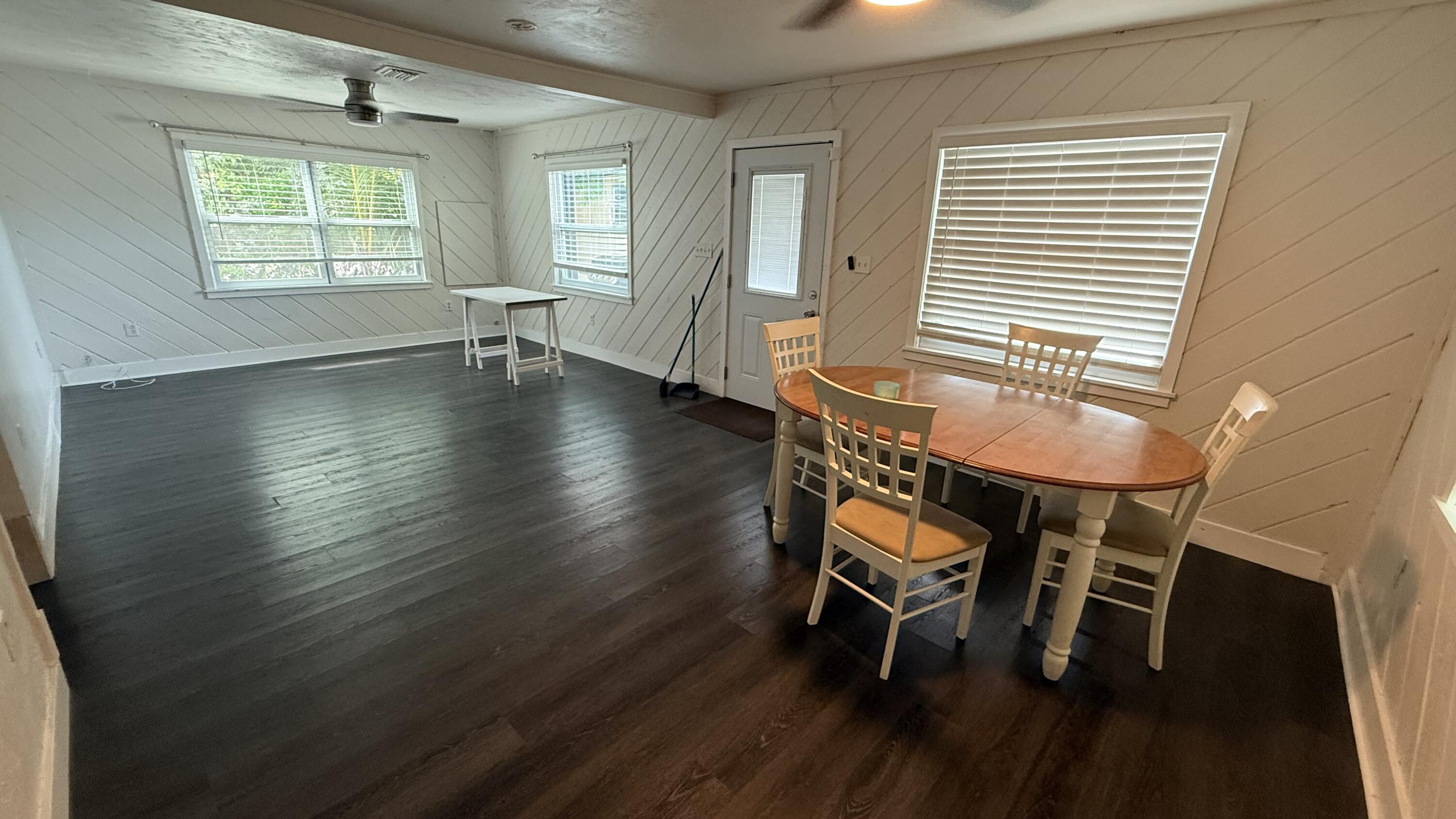 91790 Overseas Highway, Unit BACK Tavernier, FL 33070 - Photo 3 of 13 an empty room with wooden floor and a table