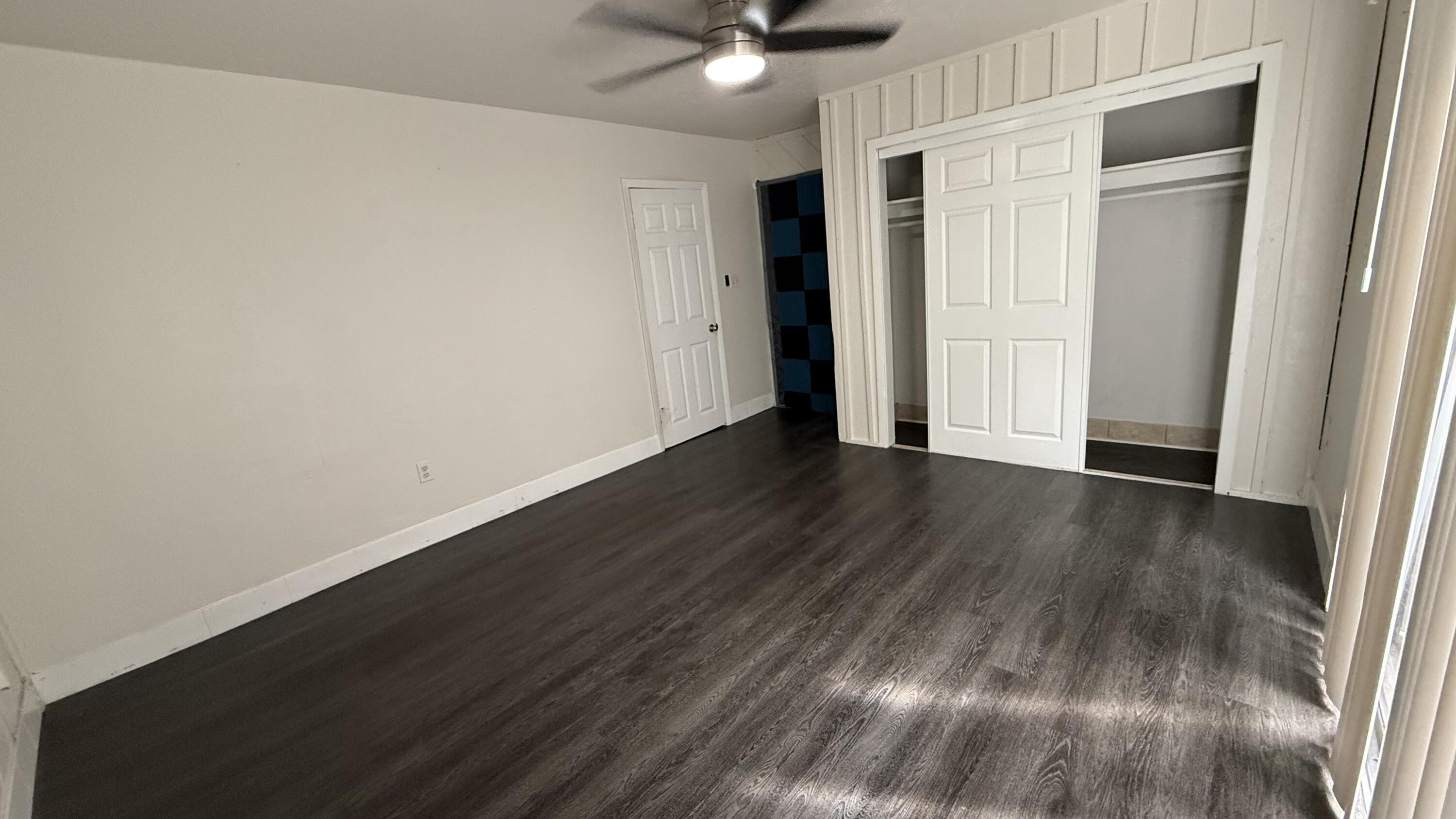 91790 Overseas Highway, Unit BACK Tavernier, FL 33070 - Photo 6 of 13 a view of an empty room with wooden floor