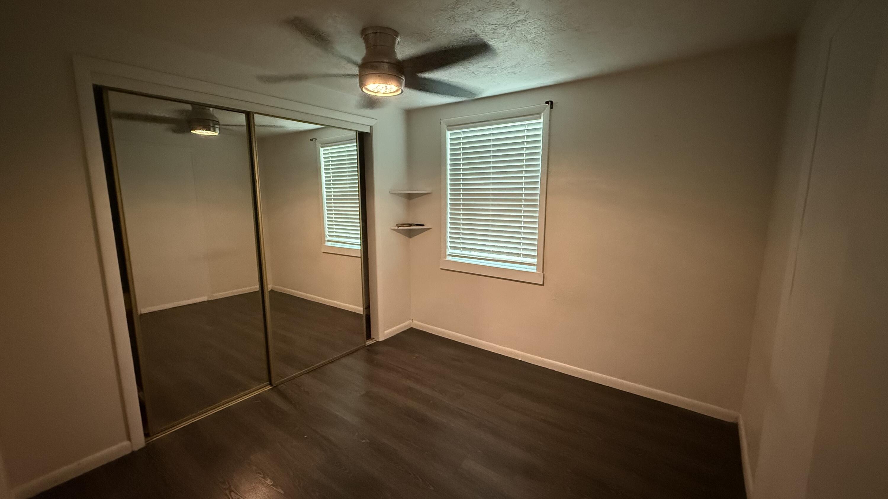 91790 Overseas Highway, Unit BACK Tavernier, FL 33070 - Photo 7 of 13 an empty room with wooden floor closet and windows