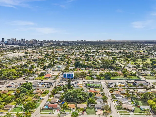 an aerial view of a house with a yard and garden