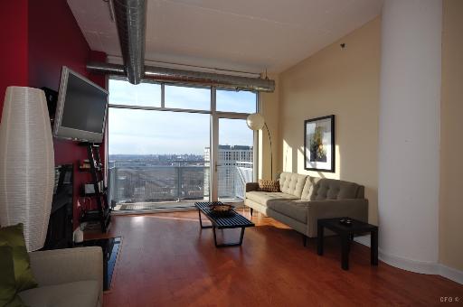 1305 South Michigan Avenue, Unit 1702 Chicago, IL 60605 - Photo 3 of 13 a living room with furniture and a floor to ceiling window