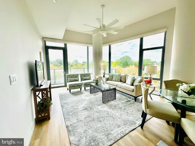 a view of a dining room with furniture a rug and wooden floor