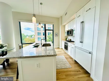 a kitchen with stainless steel appliances granite countertop a stove a microwave and a sink