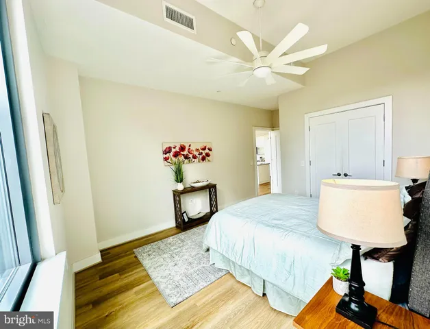 a bathroom with a double vanity sink toilet mirror and shower