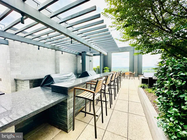 a balcony with furniture and a potted plant