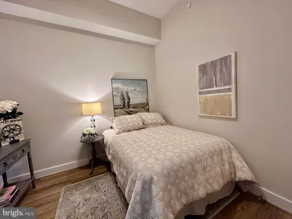 a living room with kitchen furniture and a wooden floor