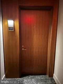 a large white kitchen with granite countertop a large window and white appliances