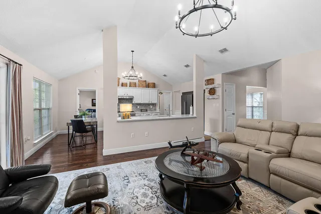 a living room with furniture a window and a table