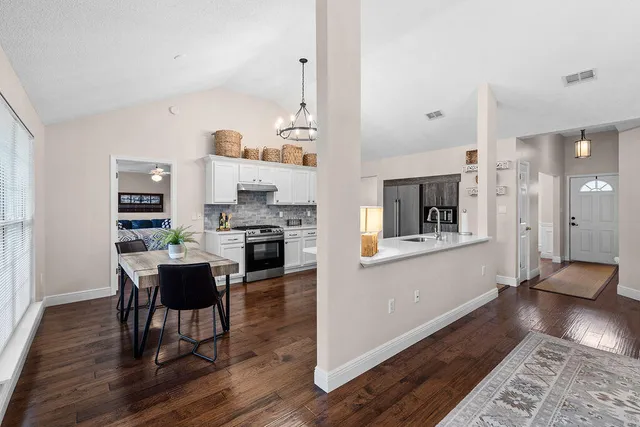 a living room with furniture and wooden floor