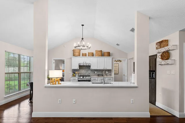 a kitchen with stainless steel appliances granite countertop a stove and cabinets