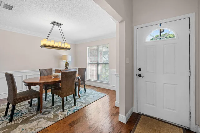 a dining room table chair and a chandelier fan