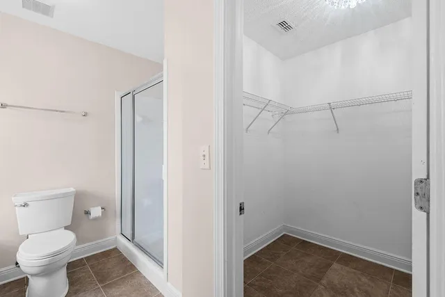 a white toilet sitting next to a bathroom sink