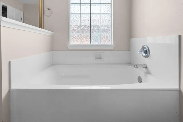 a view of a hallway with wooden floor and a living room