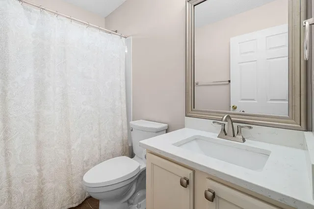 a view of a backyard with a tree