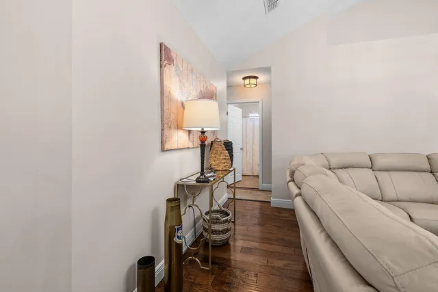 a living room with furniture and a mirror