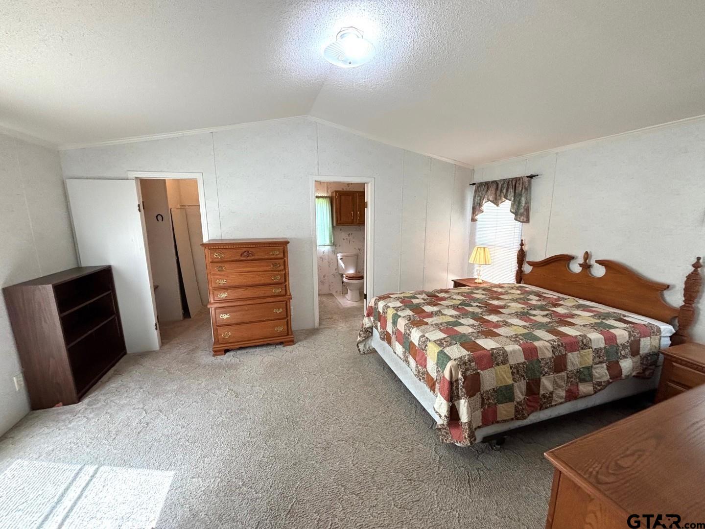 21893 Boles Road Frankston, TX 75763 - Photo 13 of 33 a bedroom with a bed and a television
