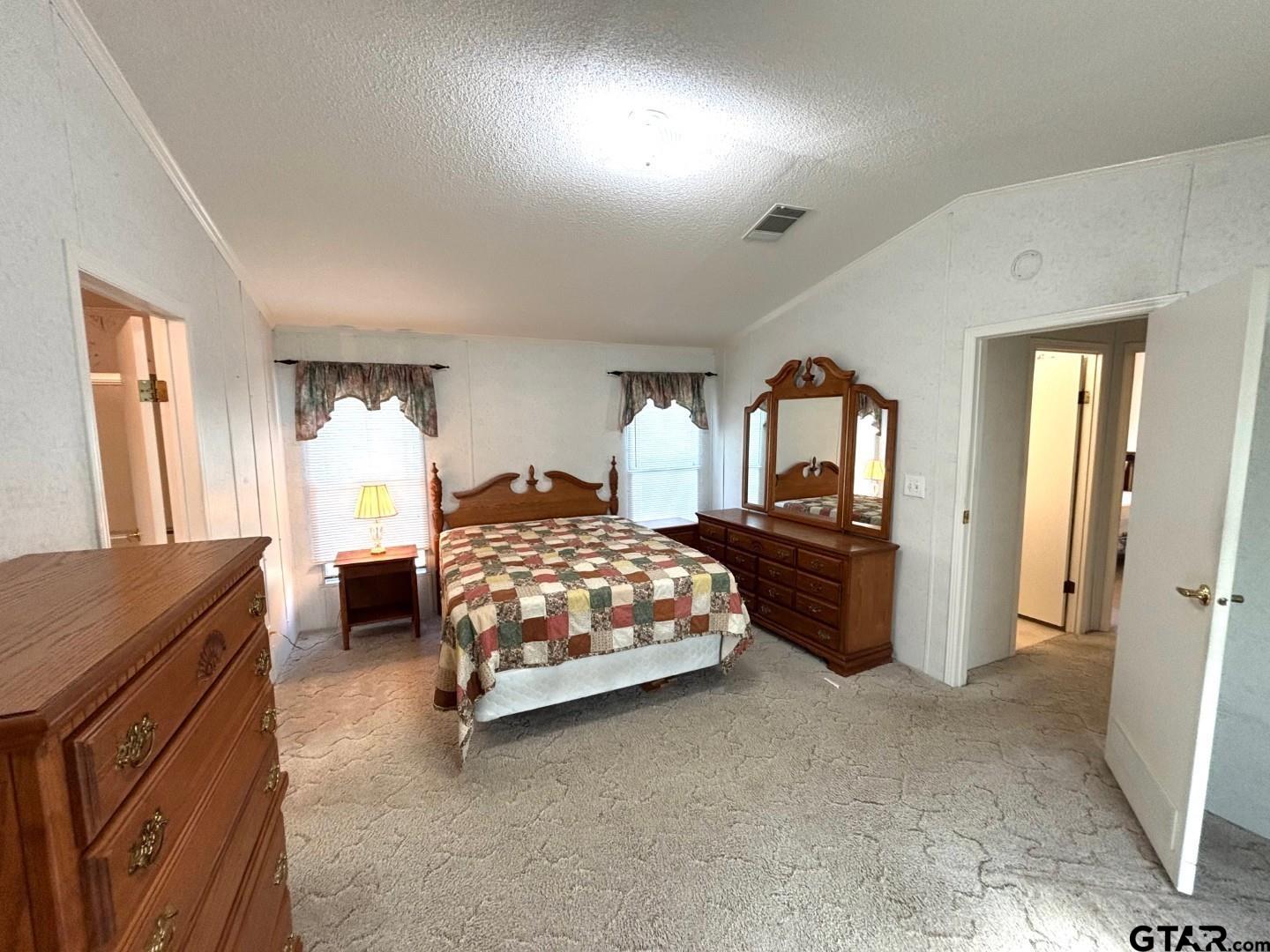 21893 Boles Road Frankston, TX 75763 - Photo 14 of 33 a bedroom with a bed and a dresser with mirror