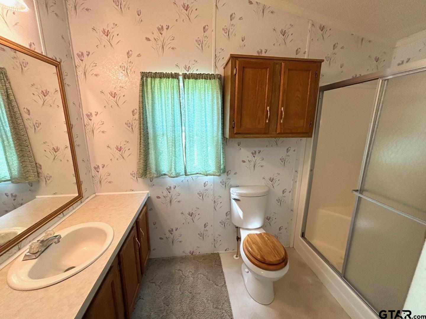 21893 Boles Road Frankston, TX 75763 - Photo 16 of 33 a bathroom with a sink a toilet and a mirror