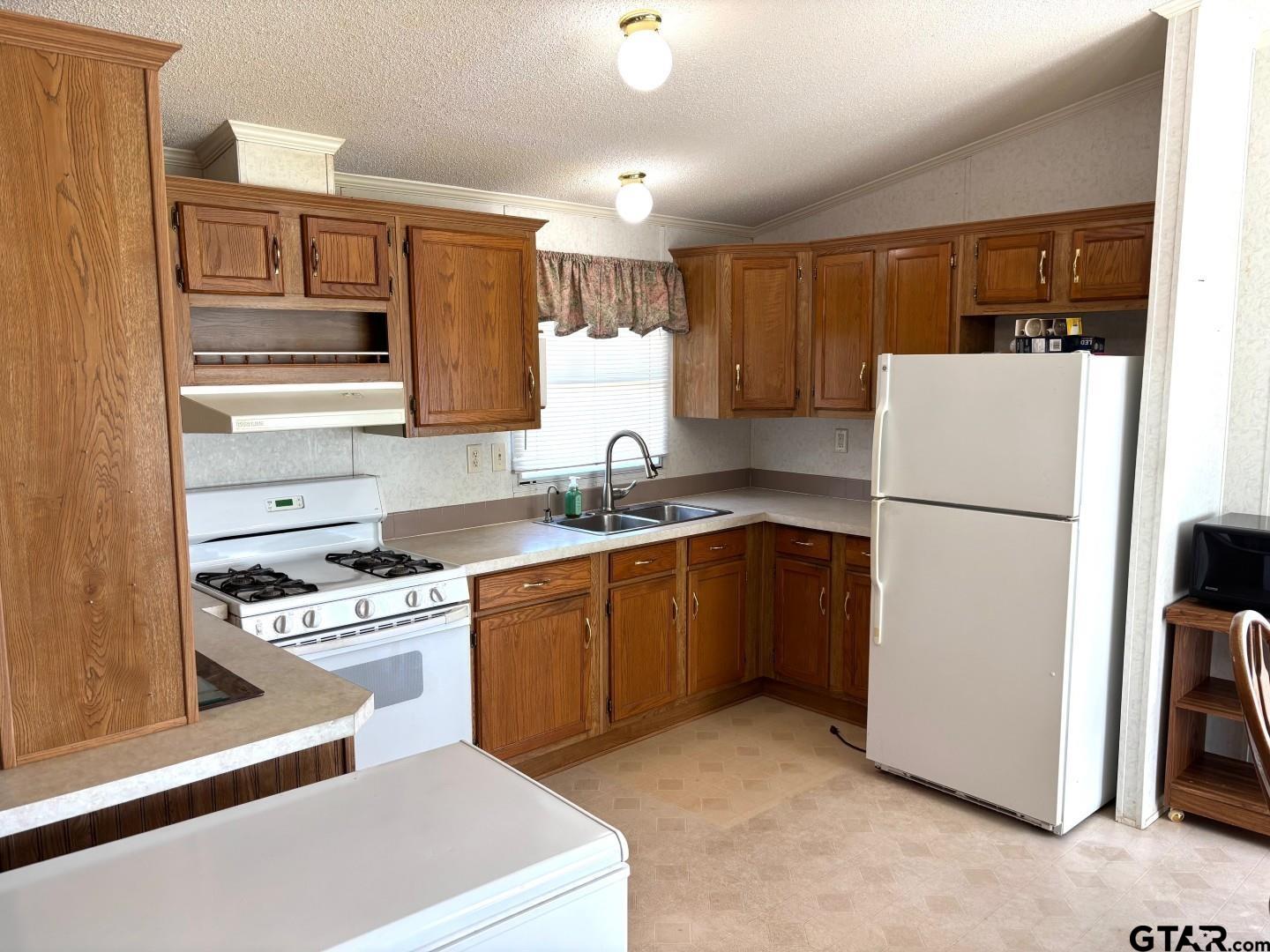 21893 Boles Road Frankston, TX 75763 - Photo 5 of 33 a kitchen with stainless steel appliances granite countertop a refrigerator sink stove and white cabinets
