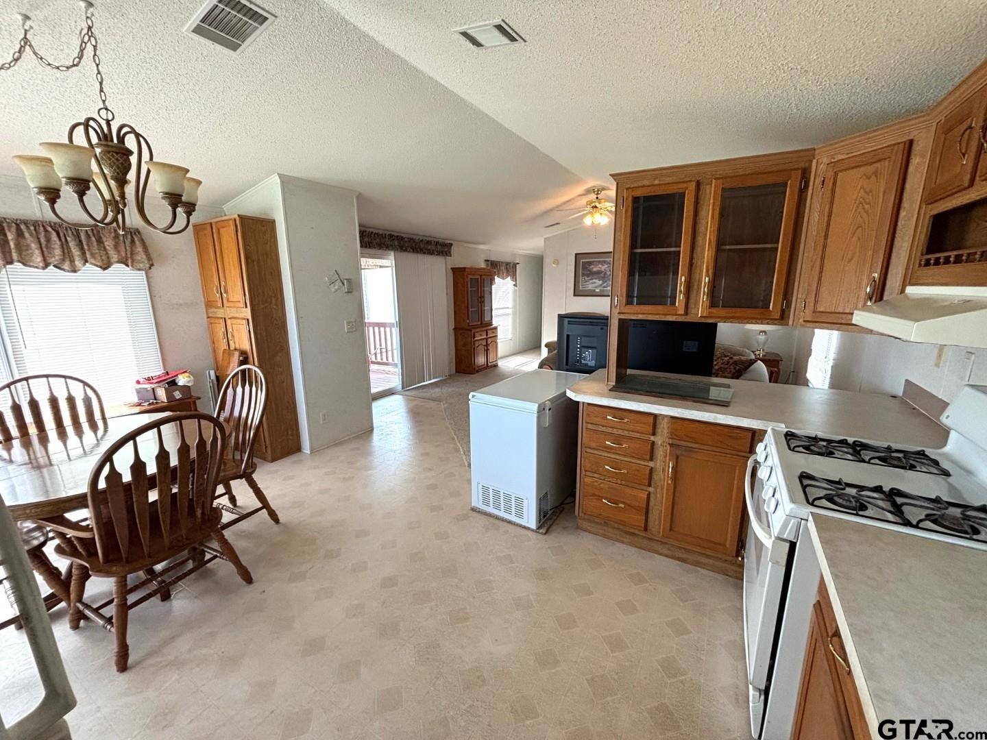 21893 Boles Road Frankston, TX 75763 - Photo 8 of 33 a living room with furniture a flat screen tv and a refrigerator